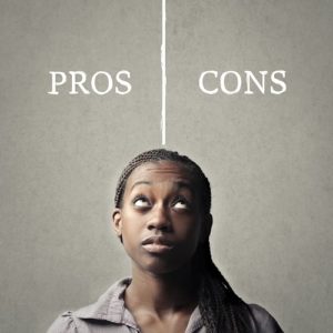 Black woman setting up a table with pros and cons