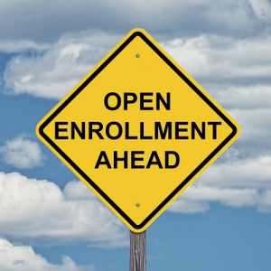 Yellow sign with open enrollment for health care.